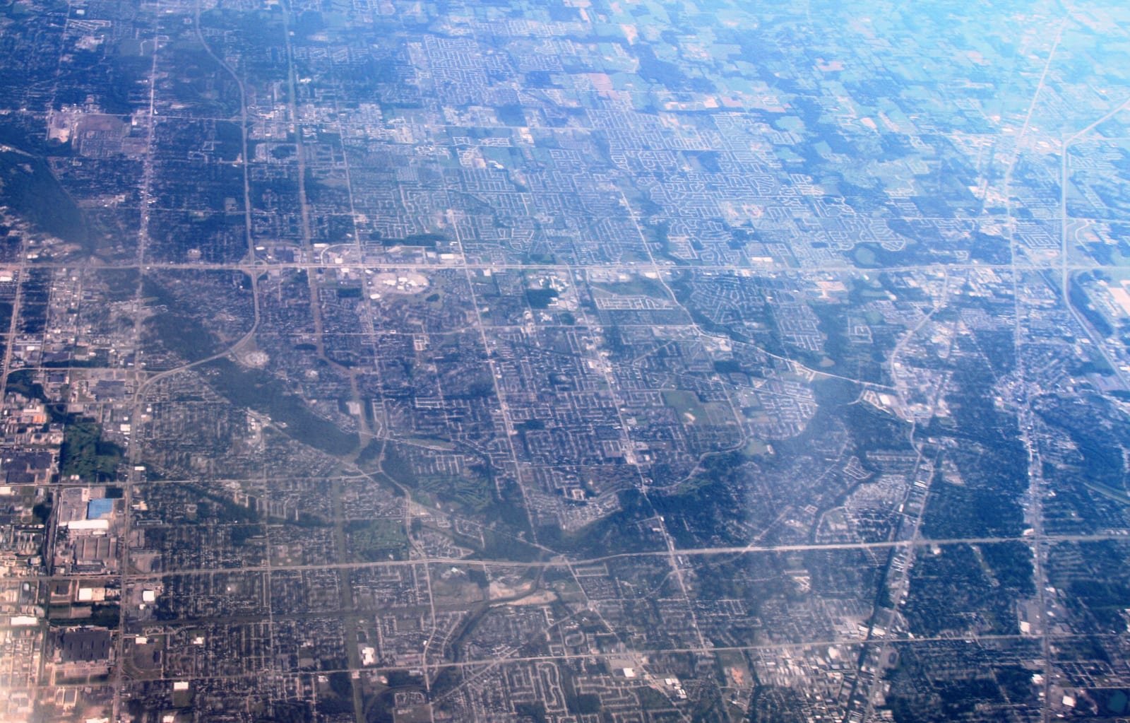 Illustrative image: aerial view of the suburban street grid of Macomb County, Michigan.